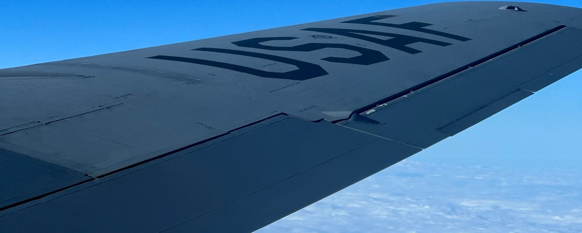 A USAF wing over the cloud deck