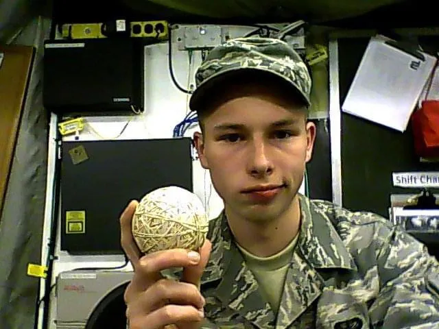 Joshua Herrington in uniform on shift, holding a large rubber-band ball