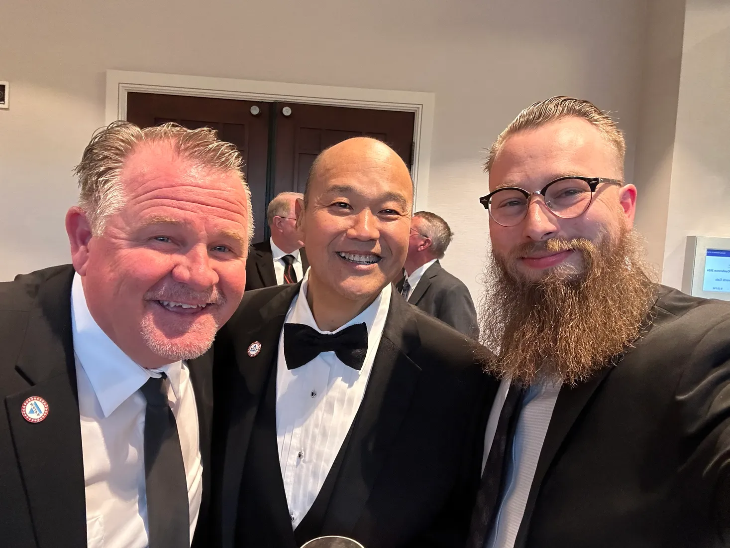 Joshua Herrington with two colleagues at the NAIFA awards gala